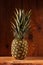 Ripe pineapple on wooden background. Healthy food ingredients, tropical fruits, diet, slimming vegan foods, weight loss