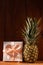 Ripe pineapple on wooden background. Healthy food ingredients, tropical fruits, diet, slimming vegan foods, weight loss