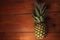 Ripe pineapple on wooden background. Healthy food ingredients, tropical fruits, diet, slimming vegan foods, weight loss