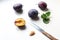 Ripe plums on the kitchen table, knife and plum slice with a stone, top view, close-up