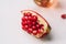 Ripe pomegranate fruit segment  on white. With clipping path.