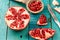 Ripe pomegranate fruit on wooden vintage background. Healthy vegetarian food.