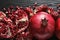 Ripe pomegranates on dark wooden background
