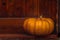 Ripe pumpkin against the background of the trees door