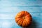 Ripe pumpkin on the blue wooden background