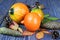 Ripe pumpkins on a blue wooden background. Autumn harvest. Healthy vegan food. Leaves and cones on a wooden table