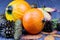 Ripe pumpkins on a blue wooden background. Autumn harvest. Healthy vegan food. Leaves and cones on a wooden table