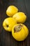 Ripe quinces on vintage wooden table