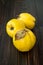 Ripe quinces on vintage wooden table