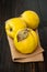 Ripe quinces on vintage wooden table