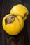 Ripe quinces on vintage wooden table