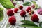 Ripe raspberries on a wooden background in green leaves, close-up, side view, bokeh-the concept of harvesting medicinal vitamin