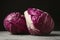 Ripe red cabbages on grey table