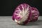 Ripe red cabbages on grey table