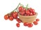 Ripe red cherry tomatoes branch in a wooden plate on a white background.