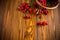 Ripe red dogrose in a basket on a wooden