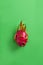 Ripe red dragon fruit isolated on colorful background