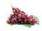 Ripe red grape. Pink bunch with leaves on white.