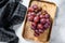 Ripe red grape. Pink bunch of ripe grape. White background. Top view