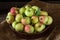 Ripe red and green apples on wooden background. Apples in bowl. Garden fruits. Autumn fruits. Autumn harvest.