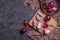 Ripe red onion bulbs cut into pieces on a cutting board, flat lay, low key photography with free copy space