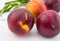 Ripe red and orange nectarines on white wood background