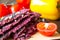 Ripe red slice of tomato with vegan dry bread loaves near it in kitchen desk