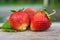 Ripe and red strawberries lie on a wooden table. Organic food, healthy nutrient