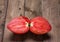 Ripe red tomato, symmetrically cut in the form of a butterfly,on a natural wooden background