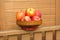 Ripe red and yellow apples in wooden bowl closeup
