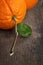 Ripe round orange with stem and leaf on wooden table