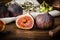 Ripe seasonal figs on wooden table with sliced one