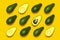 Ripe sliced avocado pattern on yellow background top view. Creative food composition Flat lay. Pop art design, tropical summer