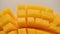 Ripe sliced juicy delicious Asian mango dice squared cubes cut moving in 4k slow motion