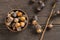 Ripe small persimmon fruit, black date or palm berries with branch on wooden background