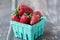 Ripe strawberries in a carton and blurred background