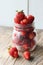 Ripe strawberries and cherries , glass jars. Wood background, rustic style.