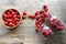 Ripe strawberries and cherries , glass jars. Wood background, rustic style.
