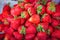 Ripe strawberries pile at street market