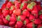 Ripe strawberries pile at street market