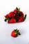 Ripe strawberries in a plastic package on a white background. Delicious fresh berries in a container for sale to