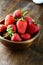 Ripe strawberries in rustic bowl