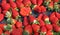 Ripe strawberry cups for sale at vegetable market