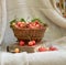 Ripe sweet cherries in a wicker basket. The basket stands on the book against the background of linen fabric. Beautiful summer