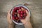 Ripe sweet cherry, hands of woman, organic dessert copy space, top view