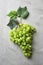 Ripe sweet grapes on grey background, top view