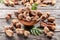 Ripe tamarind fruit, leaves and some tamarind seeds on wooden table