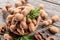 Ripe tamarind fruit, leaves and some tamarind seeds on wooden table