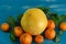 Ripe tangerines with green leaves on a bright blue background Top view flat lay copy space