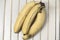 Ripe three bananas on a vintage surface